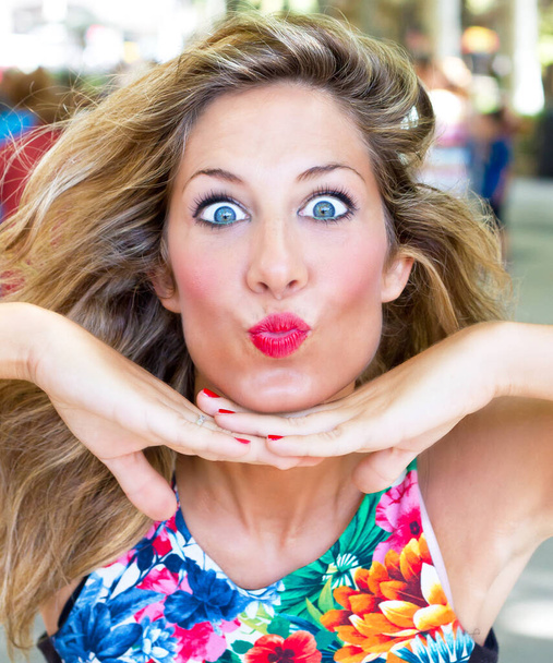 Young attractive woman making a funny kiss mouth - Photo, Image