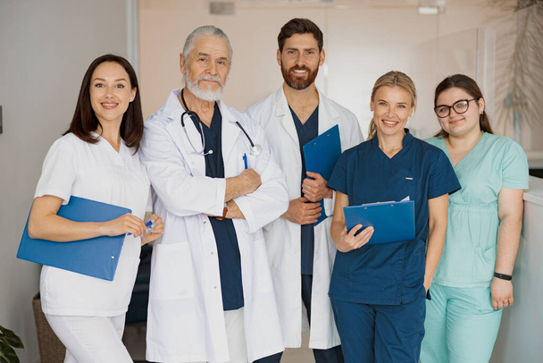 Portrait of a group of happy and successful doctors and nurses in hospital. High quality photo - Photo, Image