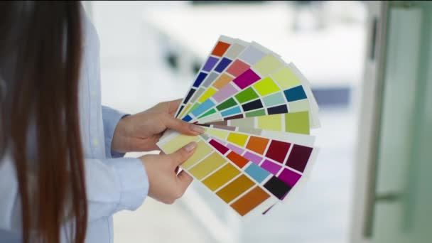 Design details. Close up shot of unrecognizable lady interior of fashion designer studying color swatches at office, slow motion - Footage, Video