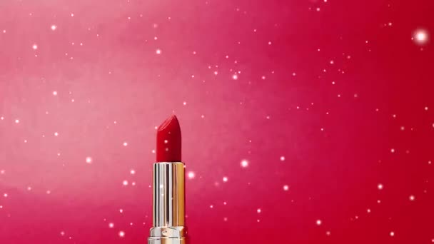 Red lipstick as luxury cosmetic product and snow at christmas time, make-up snowing ad and beauty brand concept - Footage, Video