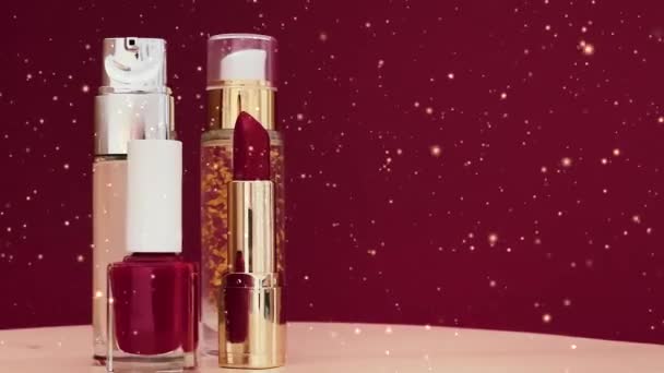Rode lippenstift, vloeibare foundaition en nagellak flessen als luxe make-up producten en gouden glitter effect, cosmetica en beauty brand concept - Video