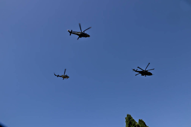 Italian military parade on 2 June. Group of helicopters flies over the Colosseum,parading in front of the offices of the Italian state. - Fotó, kép