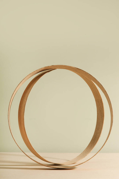  Minimalist wooden scene. Abstract minimal empty stage. Wooden rings on beige background. Mockups display for product presentation. - Photo, Image