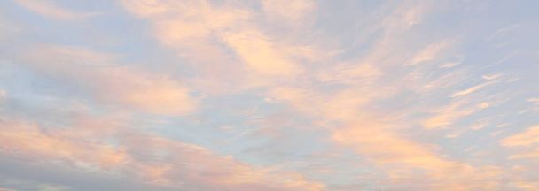 Clear blue sky with glowing pink cirrus and cumulus clouds after storm at sunset. Dramatic cloudscape. Concept art, meteorology, heaven, hope, peace, graphic resources, picturesque panoramic scenery - Foto, Bild