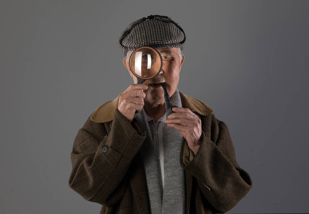 portrait of an old man with a magnifying glass - Photo, Image