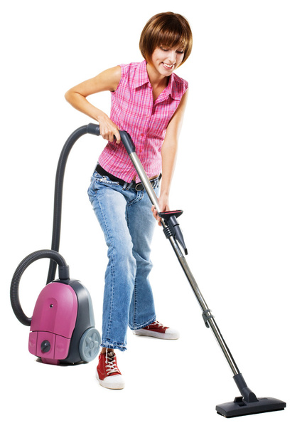 Young woman with vacuum cleaner - Foto, afbeelding