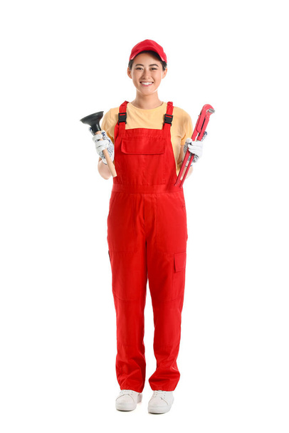 Asian female plumber with tools on white background - Фото, зображення