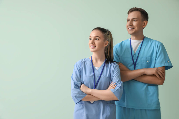 Medical assistants on green background - Foto, imagen