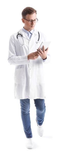 Male medical assistant using tablet computer on white background - Photo, Image