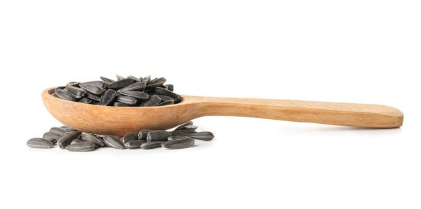 Colher de sementes de girassol preto no fundo branco - Foto, Imagem