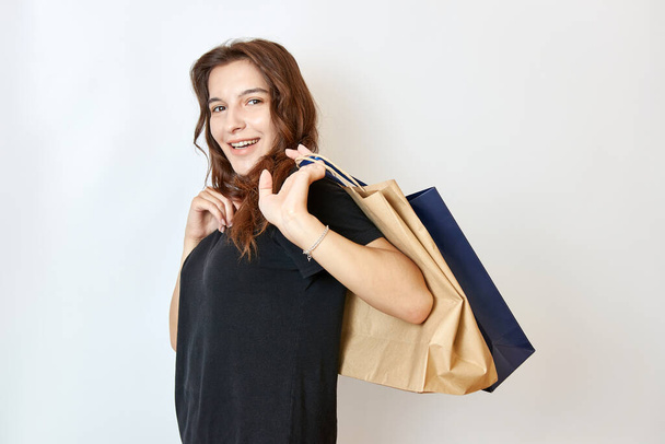 The beautiful girl made purchases and carried them in packages. Shopping concept. - Foto, Bild