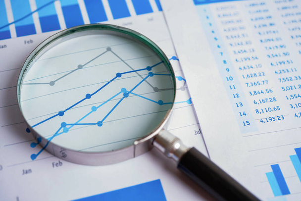 Magnifying glass on charts graphs paper. Financial development, Banking Account, Statistics, Investment Analytic research data economy, Stock exchange trading concept. - Photo, Image