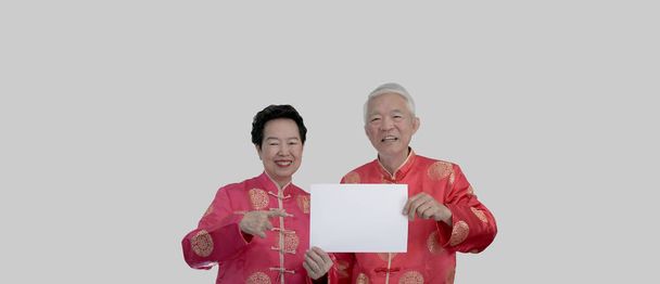 Asian senior couple Chinese new year costume holding blank sign for advertising text - Foto, Bild