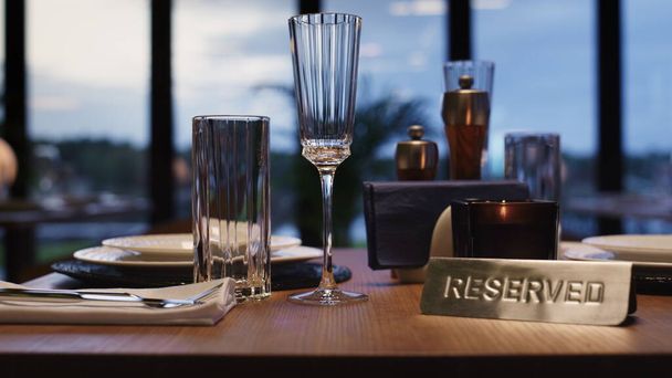 Cutlery set on reserved table in luxury modern restaurant without people. Close up reservation sign in evening loft cafe. Stylish cozy bar interior with big city background. Romantic dinner concept. - Photo, Image