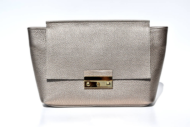 Front view of stylish grainy genuine leather clutch bag on the white glossy background. - Foto, Imagem
