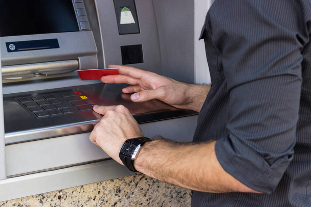 Young man using ATM  - Foto, Imagem