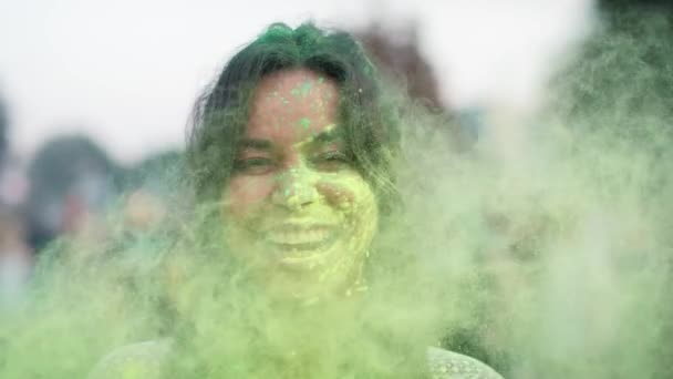 Close up of multiracial woman looking at camera at holi festival. Shot with RED helium camera in 8K.  - Кадры, видео