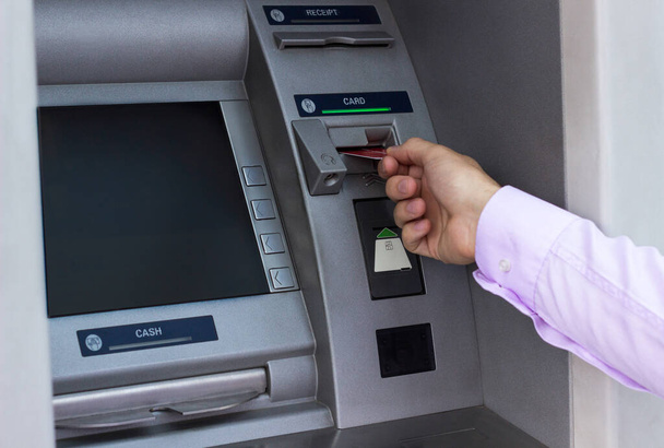 Businessman with credit card, using a ATM - Foto, Imagen
