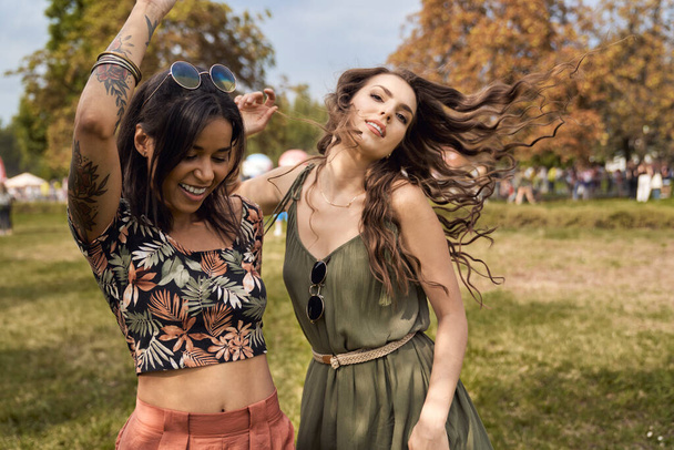 Young women dancing together at music festival  - Photo, image