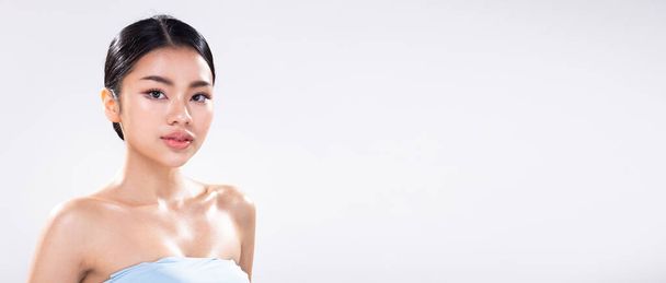 Portrait face shot of Young Asian 20s beautiful Woman open shoulder, look at camera, sweat fresh water on clean skin body. Happy female smile gently with eyes feeling over white background isolated - Photo, Image