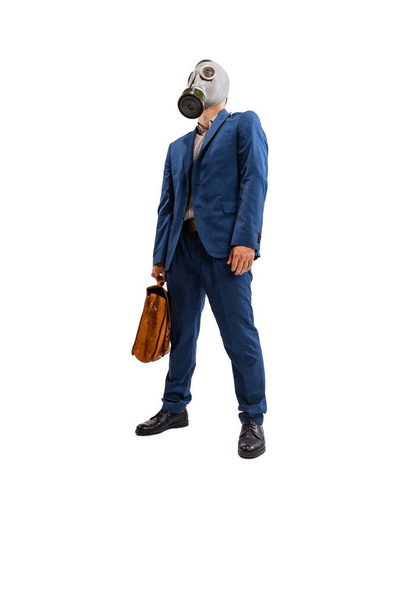 Portrait of young employee, office worker in official suit wearing gas mask isolated over white studio background. Concept of business, promotion, growth, success, challenge, strategy - Foto, immagini