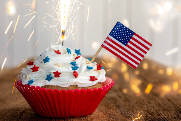 a cupcake with a flag and sparkler - Zdjęcie, obraz