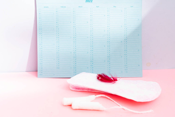 Menstrual pad with schedule card background, menstrual period and ovulation and fertility tracker, baby birth planning and natural control - Foto, imagen