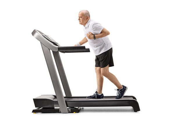 Elderly man on a treadmill having a heart attack isolated on white background - Fotoğraf, Görsel