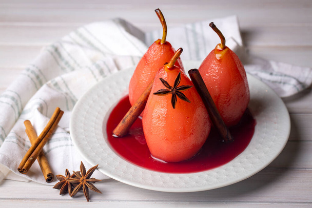 Poached pears in red wine with cinnamon and anise. - Photo, Image
