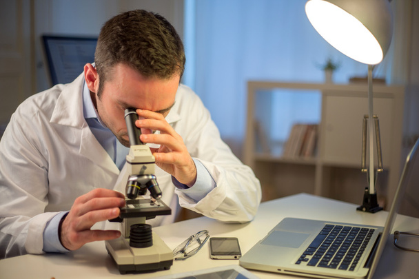 Young attractive scientist working late at office - Photo, image