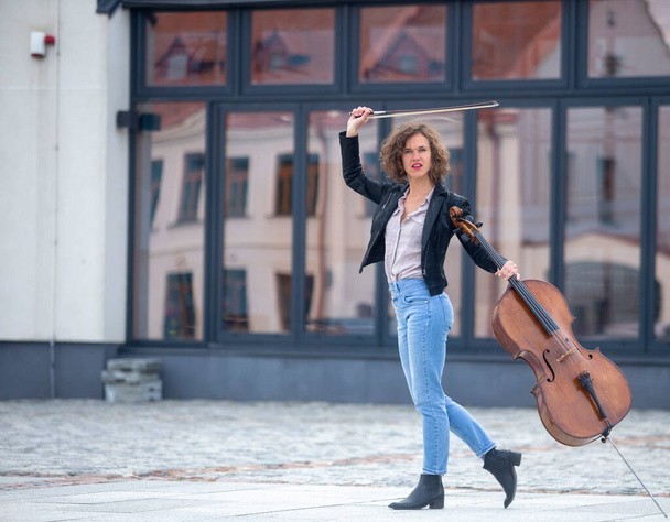 Kobieta-muzyk z wiolonczelą na ulicy - Zdjęcie, obraz