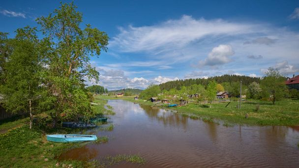 Karelian village Kurkijoki on bank of river of same name on sunny summer day. - Valokuva, kuva