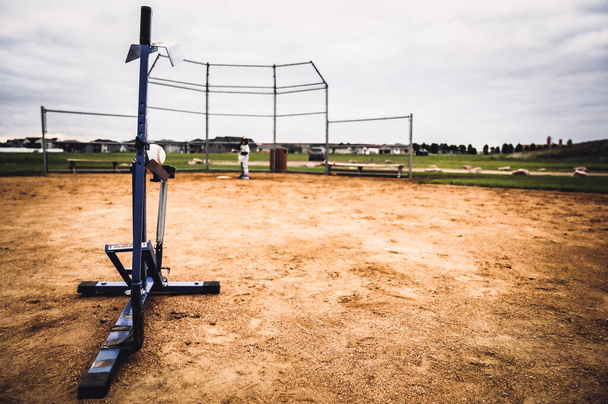 Mechanical youth slow pitching machine used to throw a baseball for batting . High quality photo - Zdjęcie, obraz