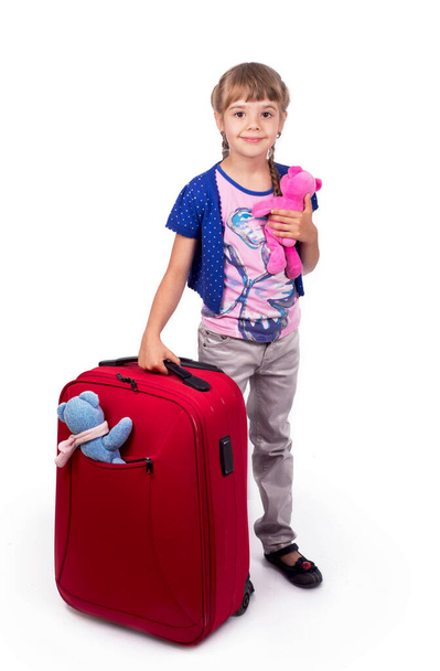 girl and big red suitcase isolated on white background - 写真・画像