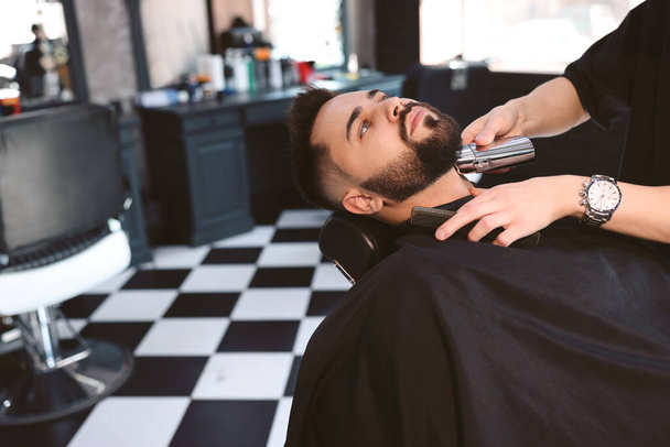 Professional hairdresser working with client in barbershop - Φωτογραφία, εικόνα