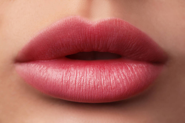 Woman with beautiful perfect lips after permanent makeup procedure, closeup - Photo, image