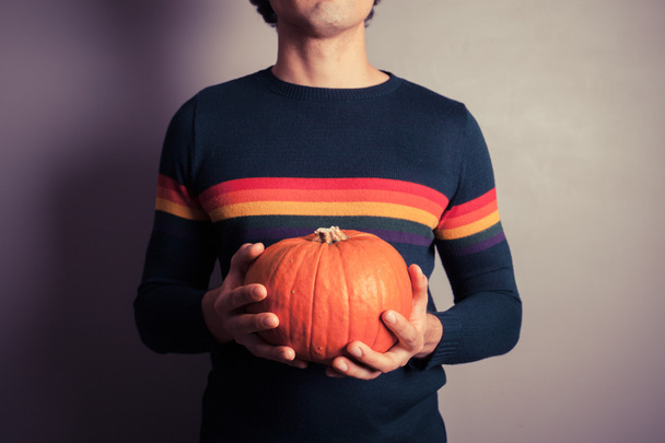 Young man with pumpkin - 写真・画像