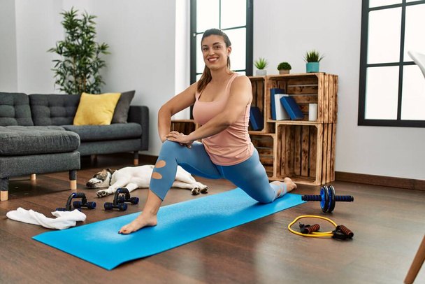 Young woman smiling confident stretching at home - Photo, Image