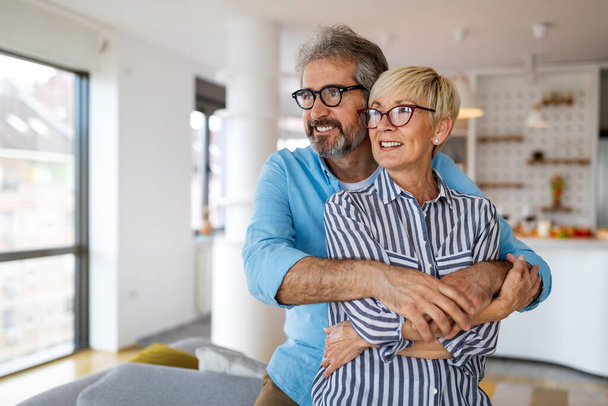 Portrait of happy mature couple in love spending time together at new home - Photo, Image