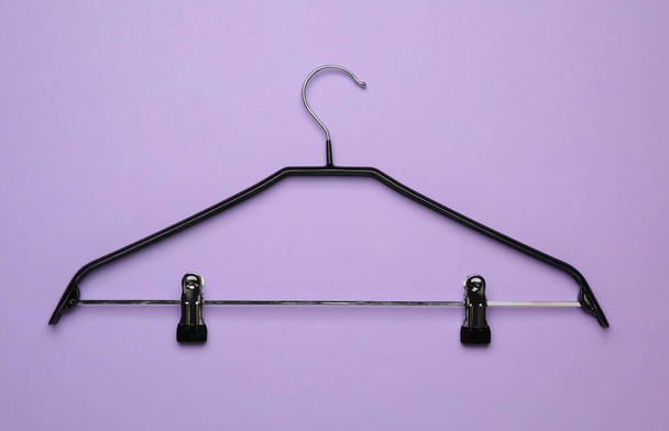 Empty clothes hanger on violet background, top view - Fotoğraf, Görsel