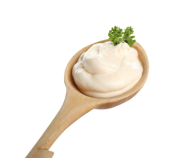 Wooden spoon with tasty mayonnaise and parsley isolated on white - Fotoğraf, Görsel