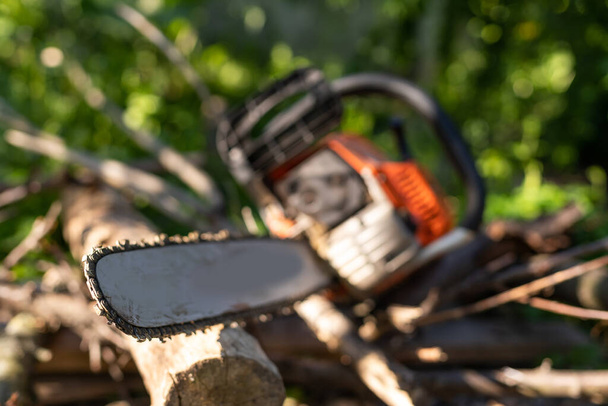 Chainsaw on wooden stump or firewood. Cut tree machine wide banner, or copy space for text. - Photo, image