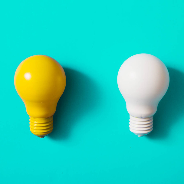 yellow white light bulb turquoise background. High resolution photo - Photo, Image