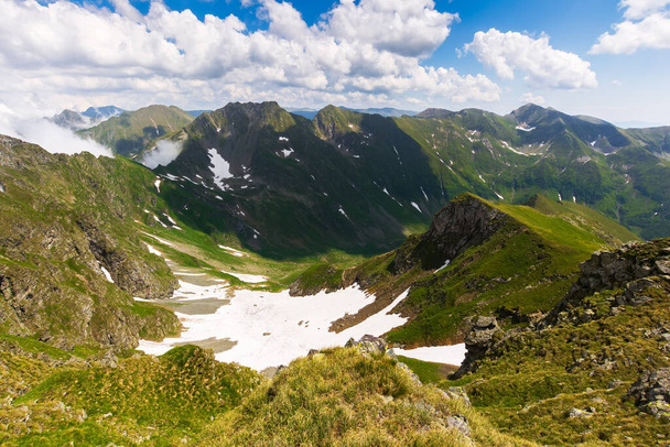landscape of fagaras mountains in summer. beautiful nature scenery of romania. steep hills, grassy meadows and rocky peaks on a sunny day. popular travel destination - Photo, Image