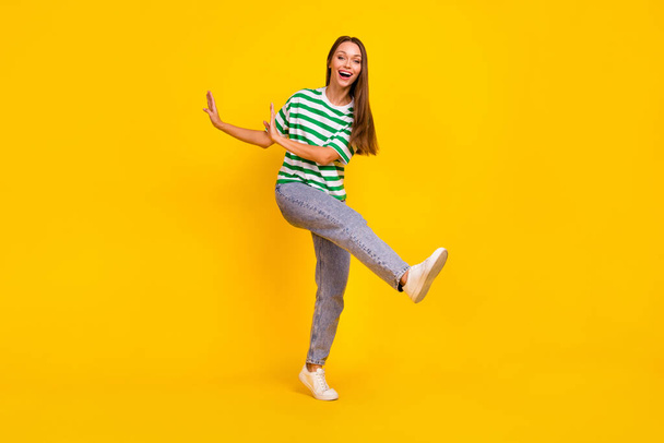 Full body photo of charming satisfied person enjoy dancing partying isolated on yellow color background. - Fotó, kép