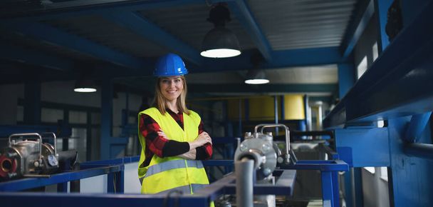 A portrait of female engineer working in industrial factory - Photo, image