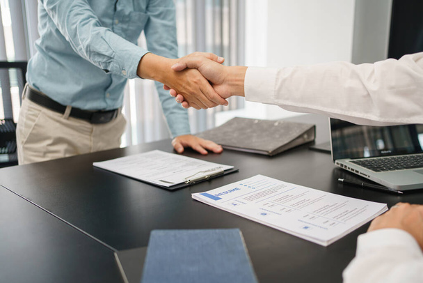 Recruitment concept, Male employer shaking hands with applicant to congratulation for new job. - Photo, Image
