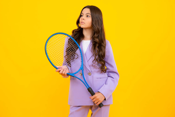 Child tennis player hold tennis racket over isolated yellow background. Sport for kids. Training for teenager girl - Φωτογραφία, εικόνα