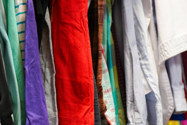 Ein Altkleidergeschäft im Zentrum der Stadt mit vielen Kleidungsstücken - Foto, Bild