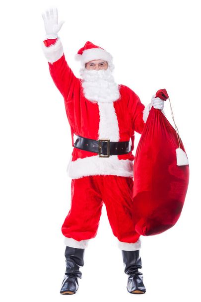 Santa Claus carrying sack with presents - Valokuva, kuva